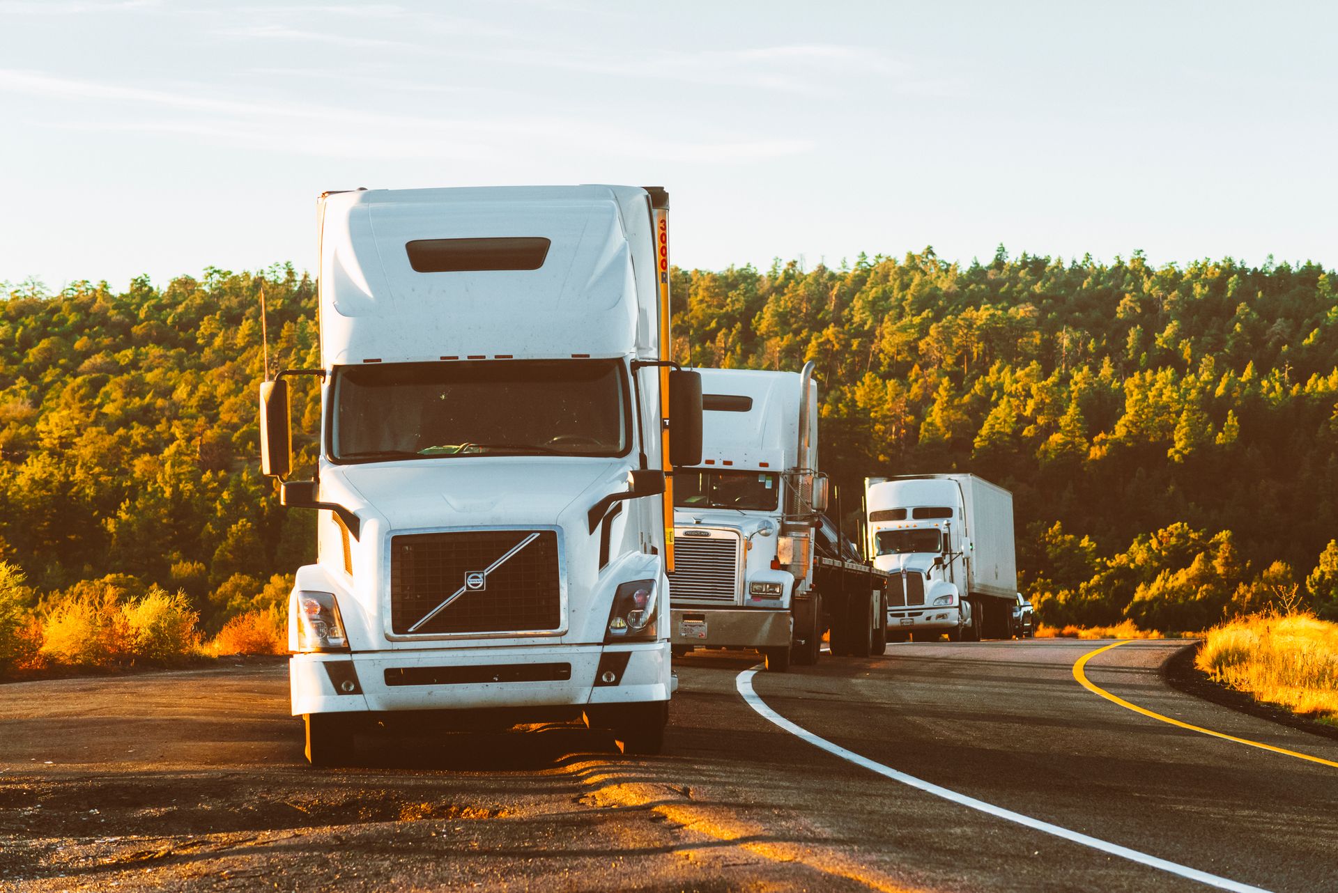 Fleet of freight trucks on the highway representing global trade network